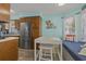 Kitchen nook features a wooden kitchen, stainless steel refrigerator, and a breakfast table at 6001 - 1308 S Kings Hwy., Myrtle Beach, SC 29575