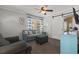 Comfortable living room with a blue sofa, stylish furniture, and a ceiling fan that adds a modern touch at 6001 - 1308 S Kings Hwy., Myrtle Beach, SC 29575