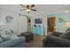 Cozy living room featuring comfortable seating, a mounted TV, and seamless flow to the adjacent kitchen and hallway at 6001 - 1308 S Kings Hwy., Myrtle Beach, SC 29575