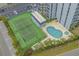 Aerial view of a tennis court and pool near the building, providing fun and recreation opportunities at 601 Mitchell Dr. # 808, Myrtle Beach, SC 29577