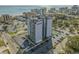 Aerial view of Holiday Towers showing a large parking lot, tennis court, palm trees, and proximity to the ocean at 601 Mitchell Dr. # 808, Myrtle Beach, SC 29577