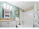 Well lit bathroom featuring a single sink, granite countertop, white cabinets, and a shower and tub combo at 601 Mitchell Dr. # 808, Myrtle Beach, SC 29577
