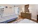 Bright bedroom featuring two beds with striped comforters, wood floors, and a doorway leading to another bathroom at 601 Mitchell Dr. # 808, Myrtle Beach, SC 29577