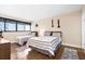 Bright bedroom featuring two beds with striped comforters, wood floors, and large window with horizontal blinds at 601 Mitchell Dr. # 808, Myrtle Beach, SC 29577