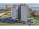 Exterior view of Holiday Towers, a modern high-rise building with a parking lot, offering convenient and stylish urban living at 601 Mitchell Dr. # 808, Myrtle Beach, SC 29577