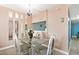 Charming dining area with a glass-top table and kitchen view, set against soft pink walls at 601 Mitchell Dr. # 808, Myrtle Beach, SC 29577
