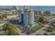 Aerial shot of condo building with a tennis court, parking lot, and close proximity to the beach at 601 Mitchell Dr. # 808, Myrtle Beach, SC 29577