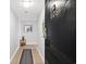 Hallway leading to the unit featuring tile floors, painting on the wall, and the door to the unit at 601 Mitchell Dr. # 808, Myrtle Beach, SC 29577