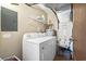 Utility room with washer, dryer, water heater, shelving, and an electrical panel on the wall at 601 Mitchell Dr. # 808, Myrtle Beach, SC 29577
