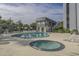 Relaxing pool area with lounge chairs, a hot tub, and a tennis court, ideal for leisure and recreation at 601 Mitchell Dr. # 808, Myrtle Beach, SC 29577
