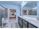 Light blue bathroom featuring a double vanity, glass shower and view into the main bedroom at 676 Lafayette Park Dr., Little River, SC 29566