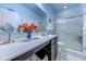 Bright bathroom with a white countertop, vanity, framed glass shower, and blue accents at 676 Lafayette Park Dr., Little River, SC 29566