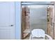 Shower with glass doors, tiled walls, and a built-in seat in a renovated bathroom at 676 Lafayette Park Dr., Little River, SC 29566