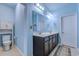 Serene bathroom with double sink vanity, ample lighting, and light blue walls at 676 Lafayette Park Dr., Little River, SC 29566