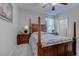 Traditional bedroom with a wooden four poster bed, lamps on nightstands and carpeted floors at 676 Lafayette Park Dr., Little River, SC 29566