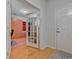 Bright foyer features hardwood floors, a view to an office space and a white entry door at 676 Lafayette Park Dr., Little River, SC 29566