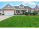 Charming single-story home featuring a well-manicured lawn and a welcoming front porch with decorative stone accents at 676 Lafayette Park Dr., Little River, SC 29566