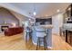 Modern kitchen with an island, pendant lighting, dark cabinetry, and a view into the adjacent living space at 676 Lafayette Park Dr., Little River, SC 29566