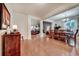 Open-concept living area showcases hardwood flooring, a dining space, and fireplace for entertaining at 676 Lafayette Park Dr., Little River, SC 29566