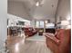 Open living area with hardwood floors, leather seating, fireplace, and a kitchen island with barstool seating at 676 Lafayette Park Dr., Little River, SC 29566