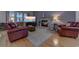 Comfortable living room with a stone fireplace, plush leather seating, and a large screen television at 676 Lafayette Park Dr., Little River, SC 29566