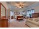 Spacious bedroom with tray ceiling, windows with curtains, ceiling fan, and comfortable furnishings at 676 Lafayette Park Dr., Little River, SC 29566