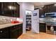 Well-organized pantry with shelving, dark wood cabinets, tile backsplash, and stainless appliances at 676 Lafayette Park Dr., Little River, SC 29566