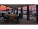 Covered patio with lighting features a dining table and seating, perfect for outdoor gatherings at 676 Lafayette Park Dr., Little River, SC 29566