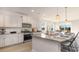 Bright kitchen features stainless steel appliances, granite countertops, and an island with seating at 750 Plumage Ct., Myrtle Beach, SC 29588
