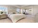 Serene main bedroom with plush bedding, ample natural light, and a charming sitting area at 750 Plumage Ct., Myrtle Beach, SC 29588
