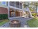 Multi-level outdoor living with a brick fire pit, covered patios, and staircase, perfect for entertaining at 80 Stonington Dr., Murrells Inlet, SC 29576