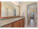 Bathroom with wood cabinets, granite countertop, large mirror, and tile flooring at 80 Stonington Dr., Murrells Inlet, SC 29576