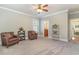 Spacious bedroom with neutral colors, plush armchairs, and doorways to an en-suite bathroom and hallway at 80 Stonington Dr., Murrells Inlet, SC 29576