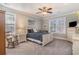 Charming bedroom with a white bed frame, rocking chair, and soft natural light from the windows at 80 Stonington Dr., Murrells Inlet, SC 29576