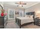 Cozy bedroom featuring a black bed, neutral walls, two windows, and modern decor at 80 Stonington Dr., Murrells Inlet, SC 29576