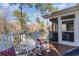 Inviting deck area offering scenic outdoor relaxation, featuring rocking chairs and glimpses of the screened porch at 80 Stonington Dr., Murrells Inlet, SC 29576