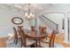 Elegant dining room with coffered ceiling, decorative chandelier, and staircase at 80 Stonington Dr., Murrells Inlet, SC 29576