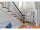 Elegant foyer featuring hardwood floors, staircase with iron spindles, and decorative front door at 80 Stonington Dr., Murrells Inlet, SC 29576