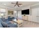 Comfortable living room featuring plush seating, a ceiling fan, and ample natural light from two windows at 80 Stonington Dr., Murrells Inlet, SC 29576