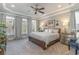 Large main bedroom with trey ceilings, large windows with custom curtains, and neutral carpeting at 80 Stonington Dr., Murrells Inlet, SC 29576