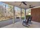 Backyard patio with a brick fire pit and rocking chairs, ideal for outdoor gatherings at 80 Stonington Dr., Murrells Inlet, SC 29576