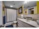 A bathroom with a vanity, white tile, and a shower with a curtain at 806 Conway St. # 309, North Myrtle Beach, SC 29582