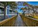 Charming blue condo exterior with wooden walkway and lovely views of the surrounding nature at 806 Conway St. # 309, North Myrtle Beach, SC 29582