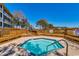 Outdoor hot tub area featuring wooden benches and railings, offering a relaxing retreat at 806 Conway St. # 309, North Myrtle Beach, SC 29582