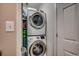 A laundry room with stacked washer and dryer units and a shelf at 806 Conway St. # 309, North Myrtle Beach, SC 29582