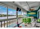 A screened porch with a ceiling fan, chairs, tables, and a view of the lake at 806 Conway St. # 309, North Myrtle Beach, SC 29582