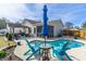 Landscaped backyard featuring a sparkling pool, comfortable seating, and an inviting patio area at 8091 Bark Ct., Murrells Inlet, SC 29576