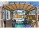 Relaxing backyard featuring a charming pergola, stylish patio furniture, and a sparkling pool at 8091 Bark Ct., Murrells Inlet, SC 29576