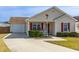 Inviting single-story home featuring an attached garage and manicured landscaping at 8091 Bark Ct., Murrells Inlet, SC 29576