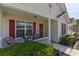 Close-up of the welcoming front porch with seating and charming details at 8091 Bark Ct., Murrells Inlet, SC 29576